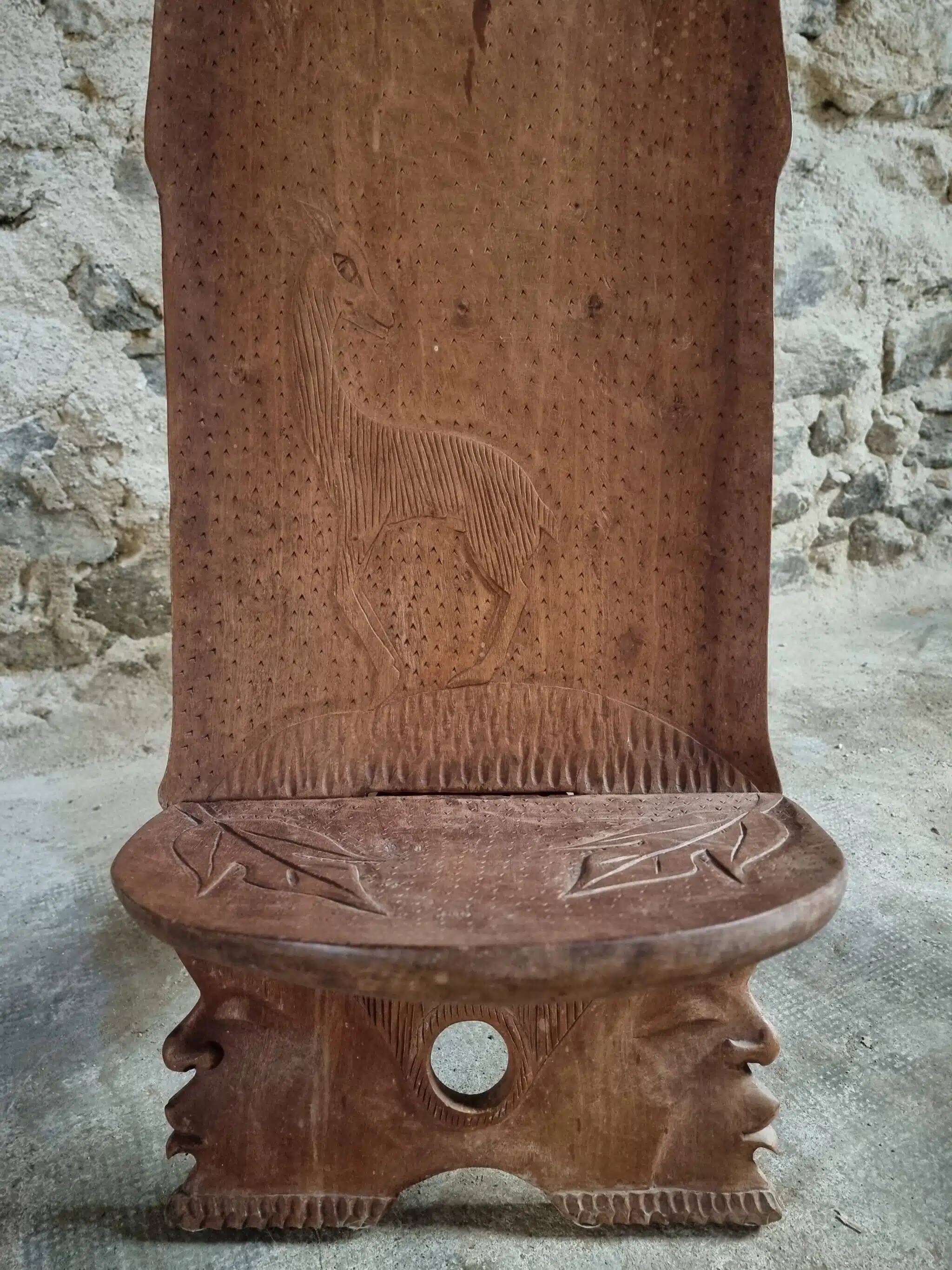 Pair of hand-carved wooden folding chairs – African origin, animal and face motifs, mid-20th century