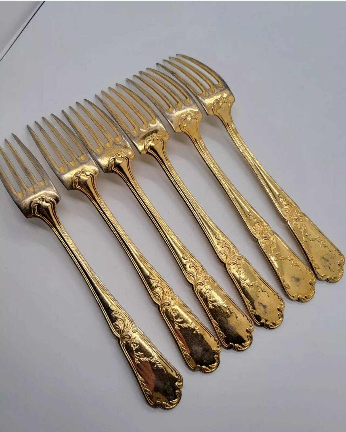 12 Table Forks in gold metal