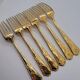 12 Table Forks in gold metal