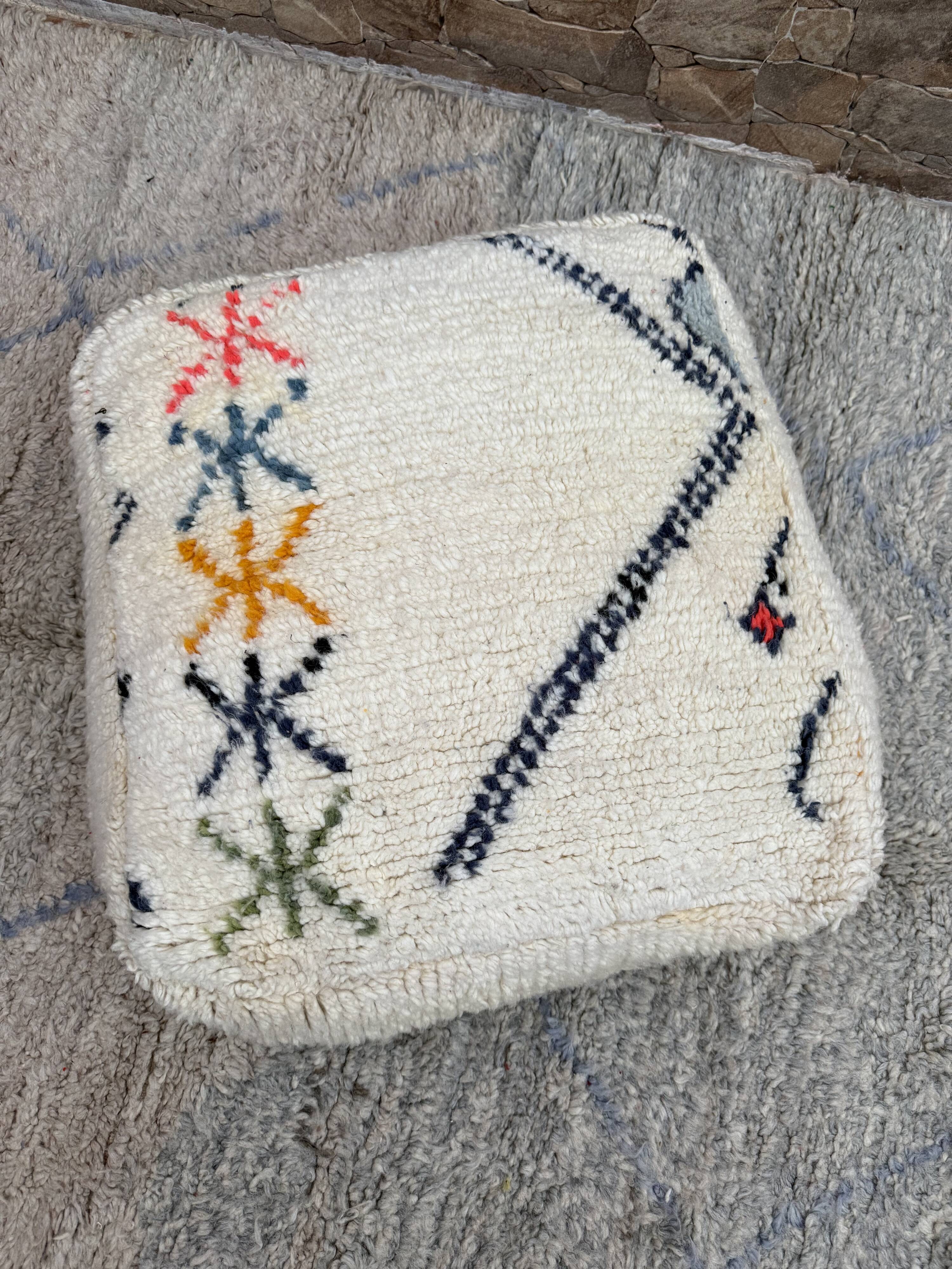 Berber floor pouf: Handwoven Moroccan wool cushion.