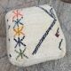 Berber floor pouf: Handwoven Moroccan wool cushion.