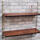 Shelf 1950 has 70 gold uprights and and plating shelf with black plastic border,