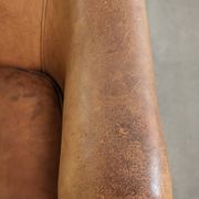 Comfortable sheepskin club armchair in a cognac colour