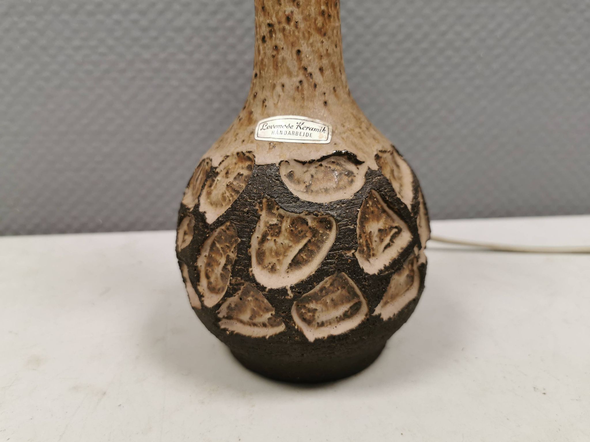 Small beautiful ceramic table lamp in earth colors.