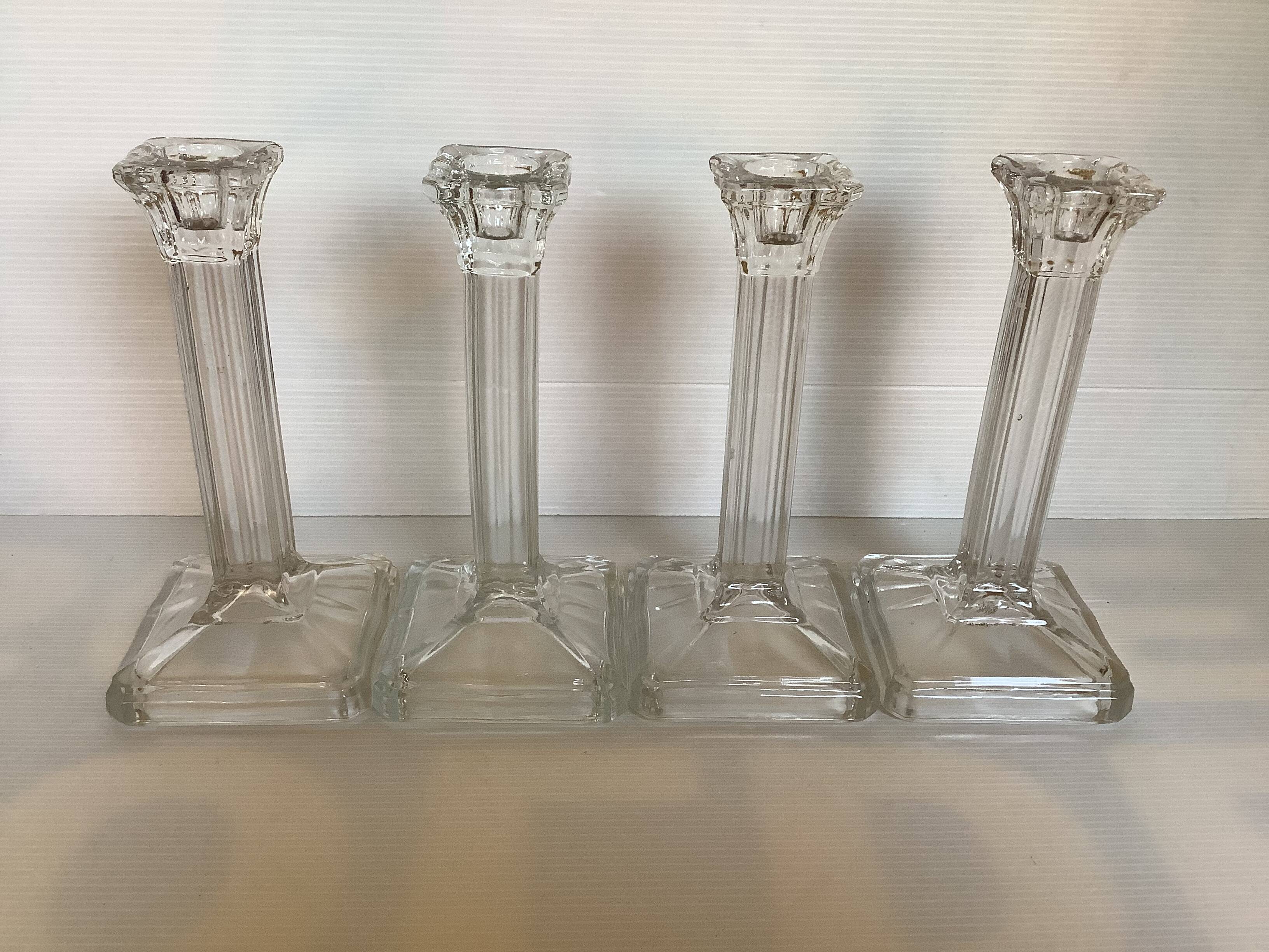 Four old square molded glass candlesticks