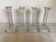 Four old square glass moulded candlesticks.