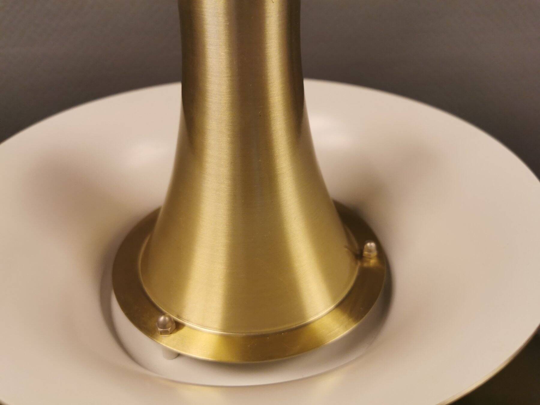 Large hanging lamp, made of brass-coloured aluminium with red and white contrast lacquer inside.