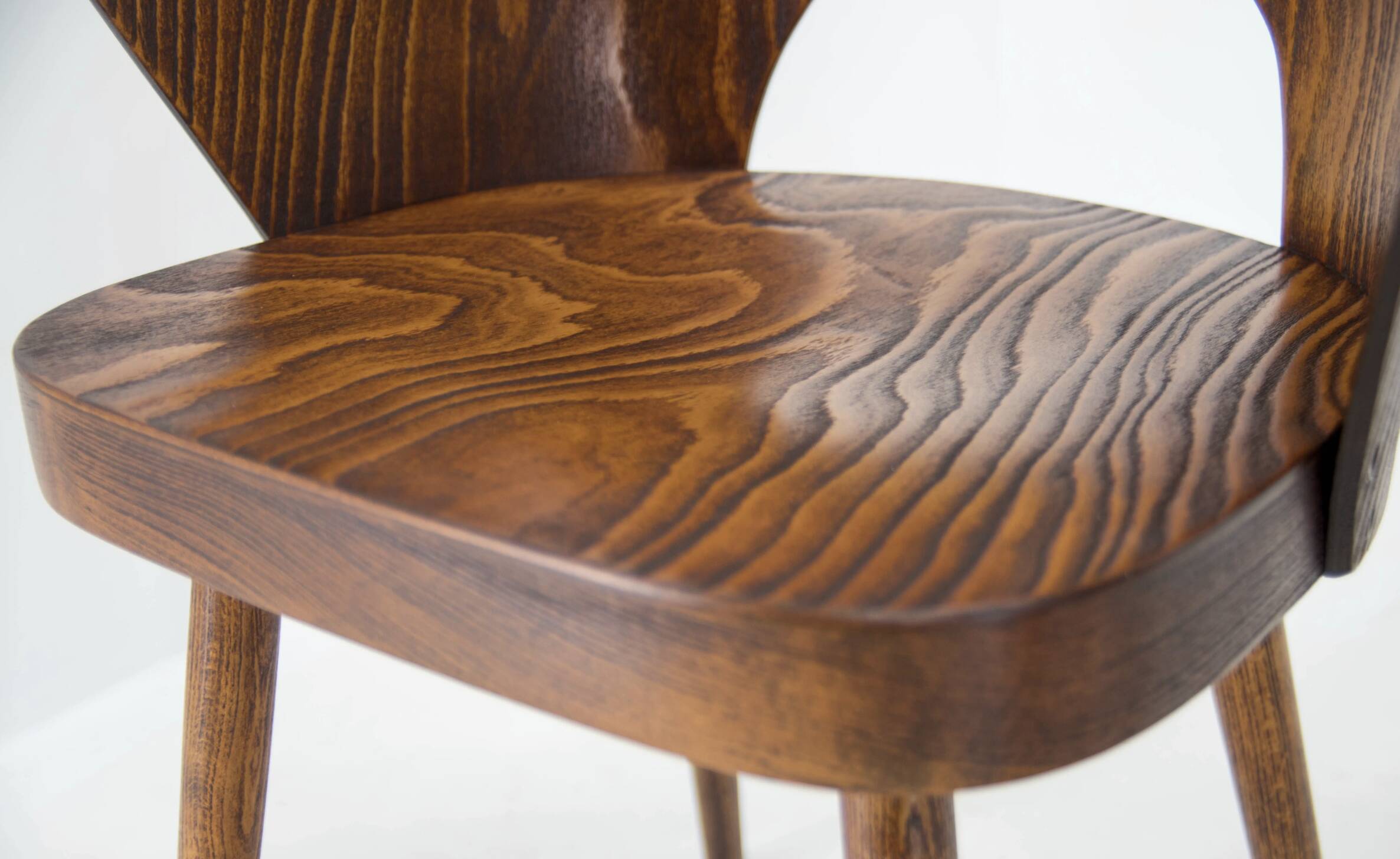 Pair of curved wooden shell armchairs in the style of Oswald Haerdtl.