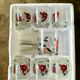 The service of 6 whiskey glasses with red flowers, with its bucket and its ice cube tongs.
