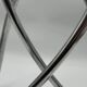 Chromed sculptural art object, abstract modernist shape in metal, contemporary design accent, brutalist interior decoration.
