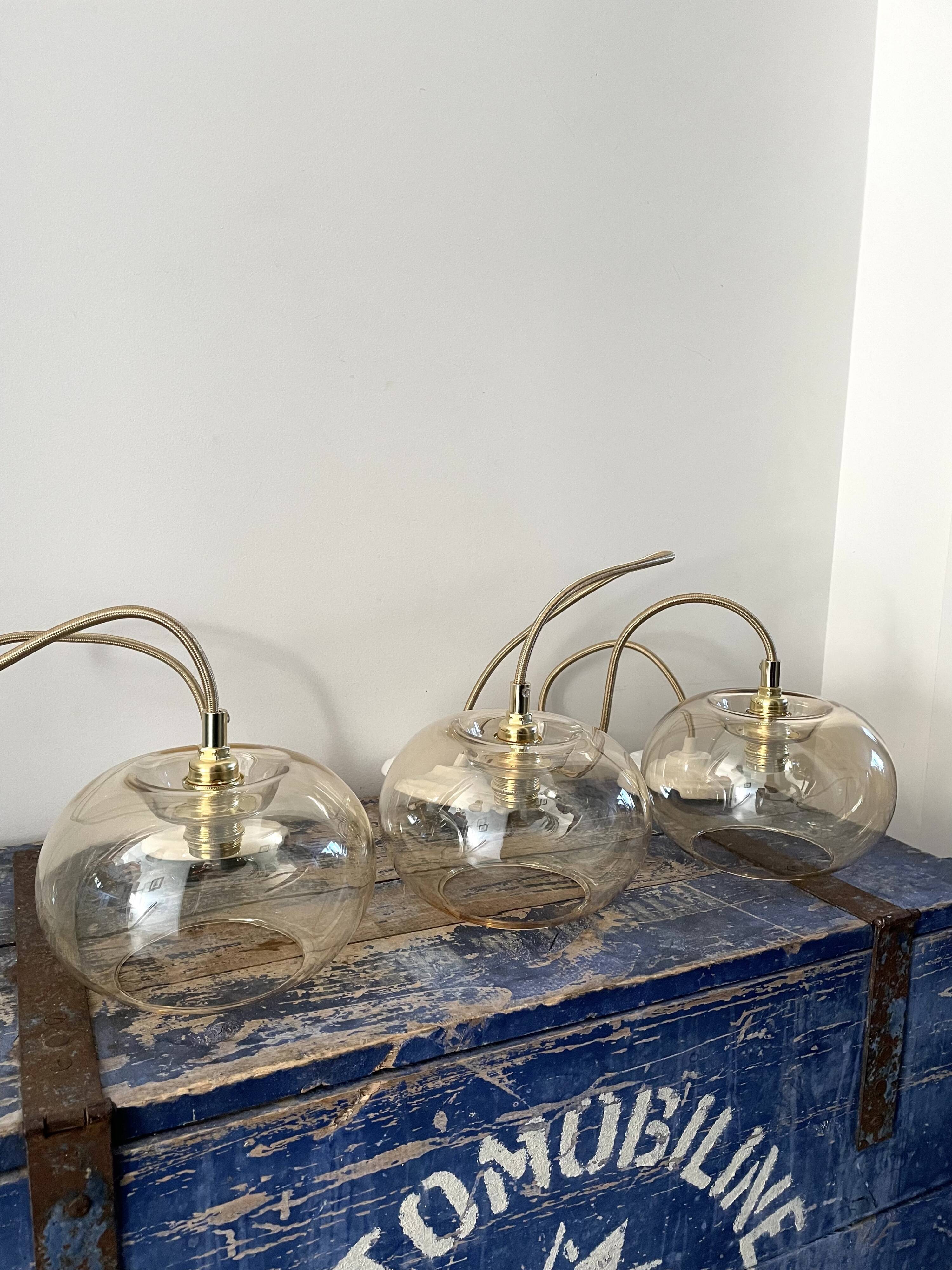 Set of three new electrified golden glass pendant lamps