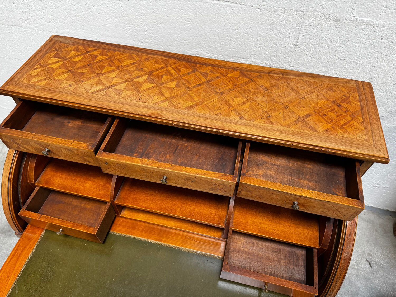 Cylinder desk with marquetry featuring a crosshatch design.