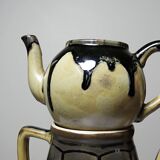 A pair of small vintage teapots in the Art Deco style reminiscent of Denbac.