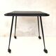Black table on wheels from the 60s