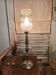 Table lamp with a golden base and its elongated bubbled glass globe.