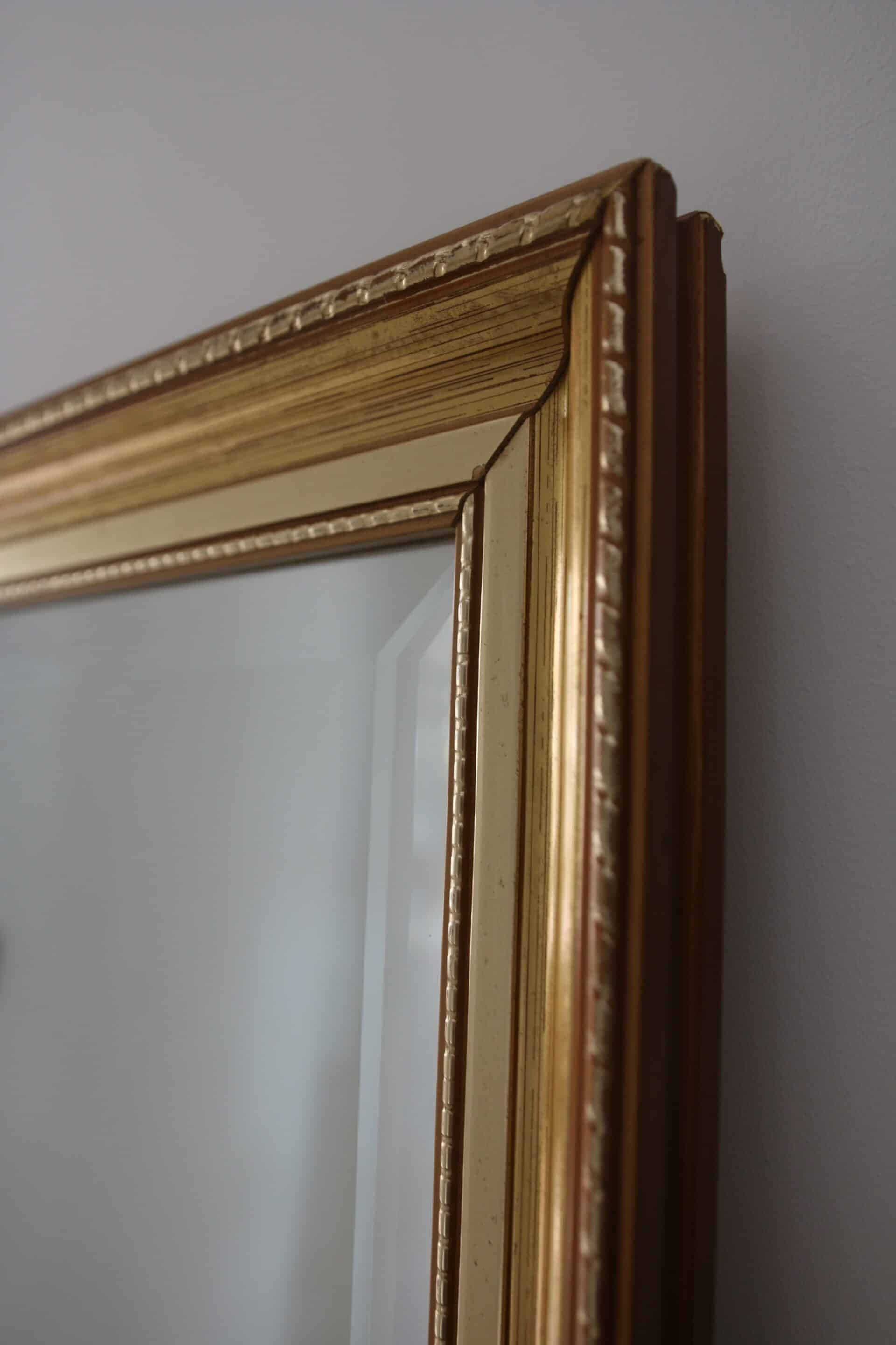 Large beveled mirror in carved wood