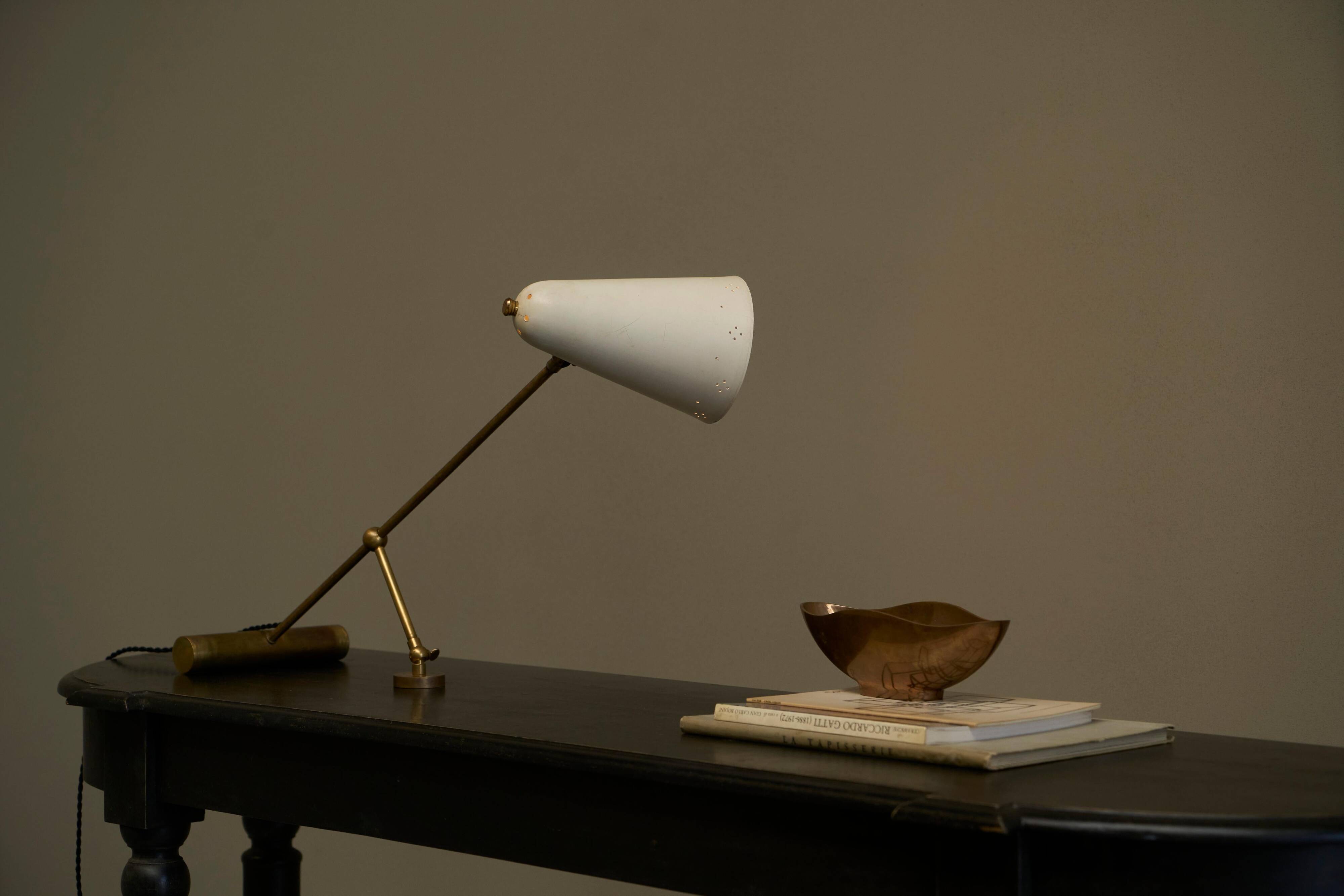 Mid Century adjustable table lamp with perforated shade from the 1950s.