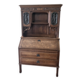 Large secretary with a drop-down front in carved oak, neo-Renaissance style.