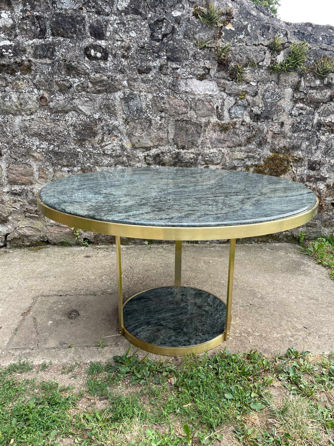 Round dining table with green marble and solid brass.