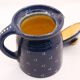 Pitcher and navy blue lid with off-white peas