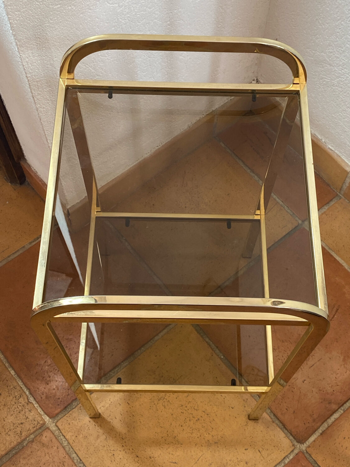 Gold metal and smoked glass console table.