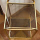 Gold metal and smoked glass console table.