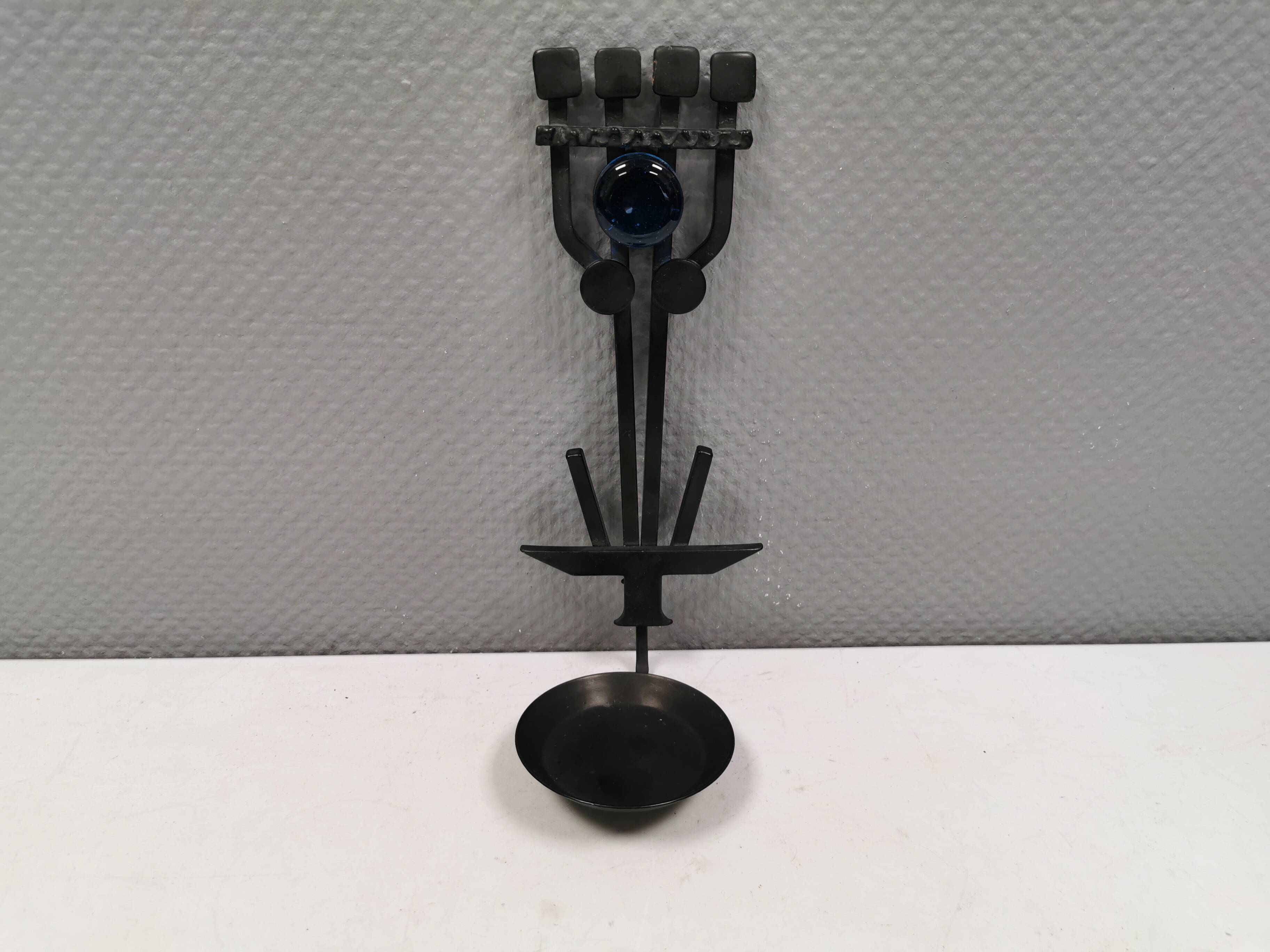 Vintage wall candle holder in wrought iron and hard pressed blue glass.