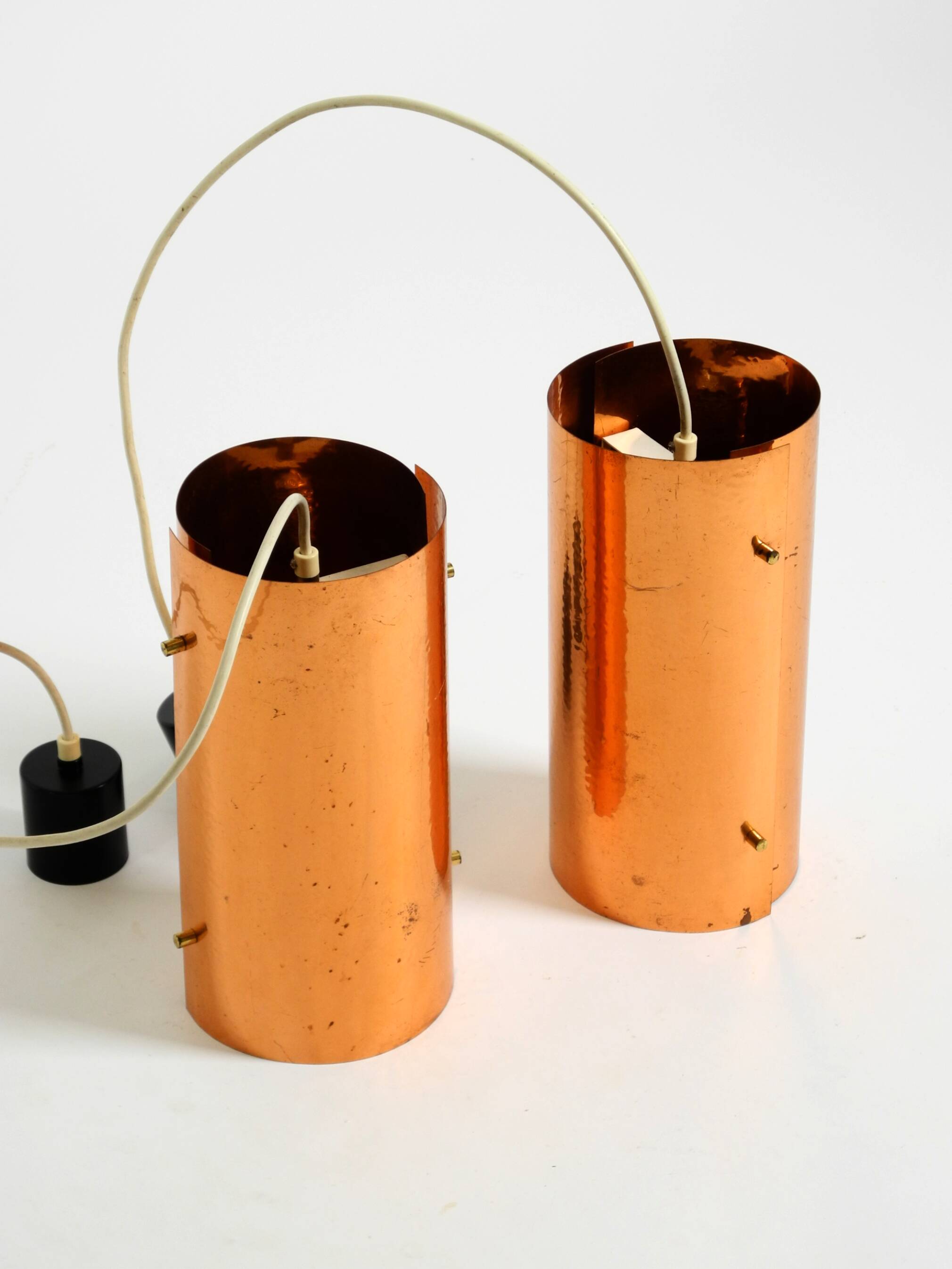 Two 50s tube pendant lamps consisting of two screwed-together copper bowls