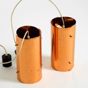 Two 50s tube pendant lamps consisting of two screwed-together copper bowls