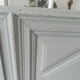 Headboard made with an old walnut door, re-enchanted in gray green waxed finish,