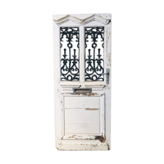 Old door with wrought iron grille
