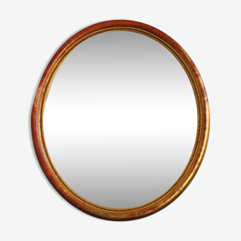 Golden stucco oval mirror