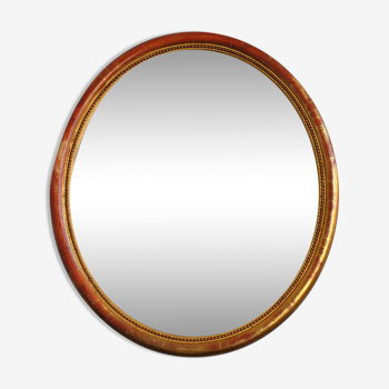Miroir ovale de style en stuc doré