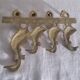 Wall-mounted tea towel holder or key holder in brass with ducks.