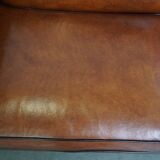 Very beautiful complete set consisting of a sheepskin leather sofa and two armchairs in cognac color