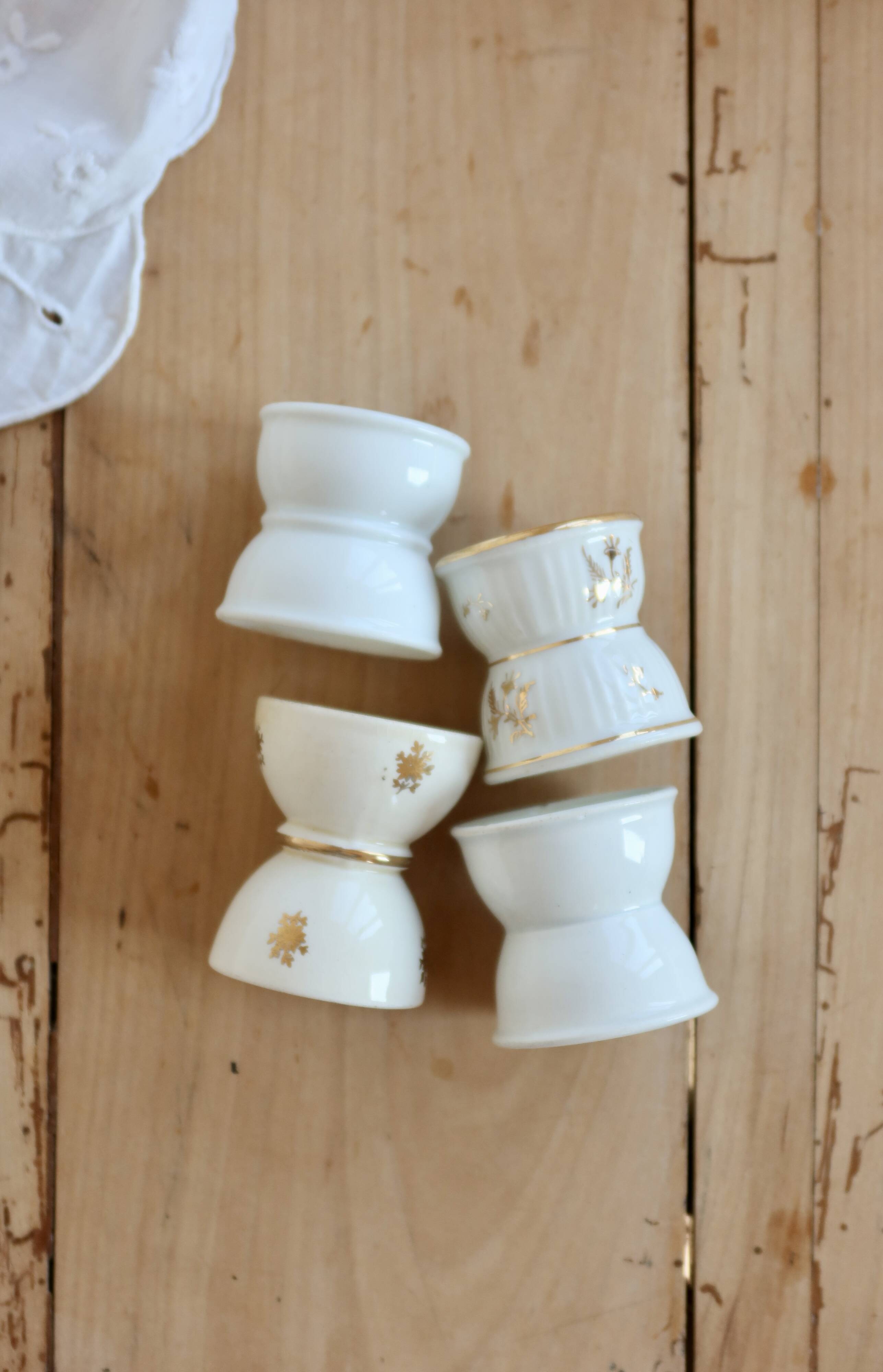 4 mismatched vintage diabolo egg cups in earthenware