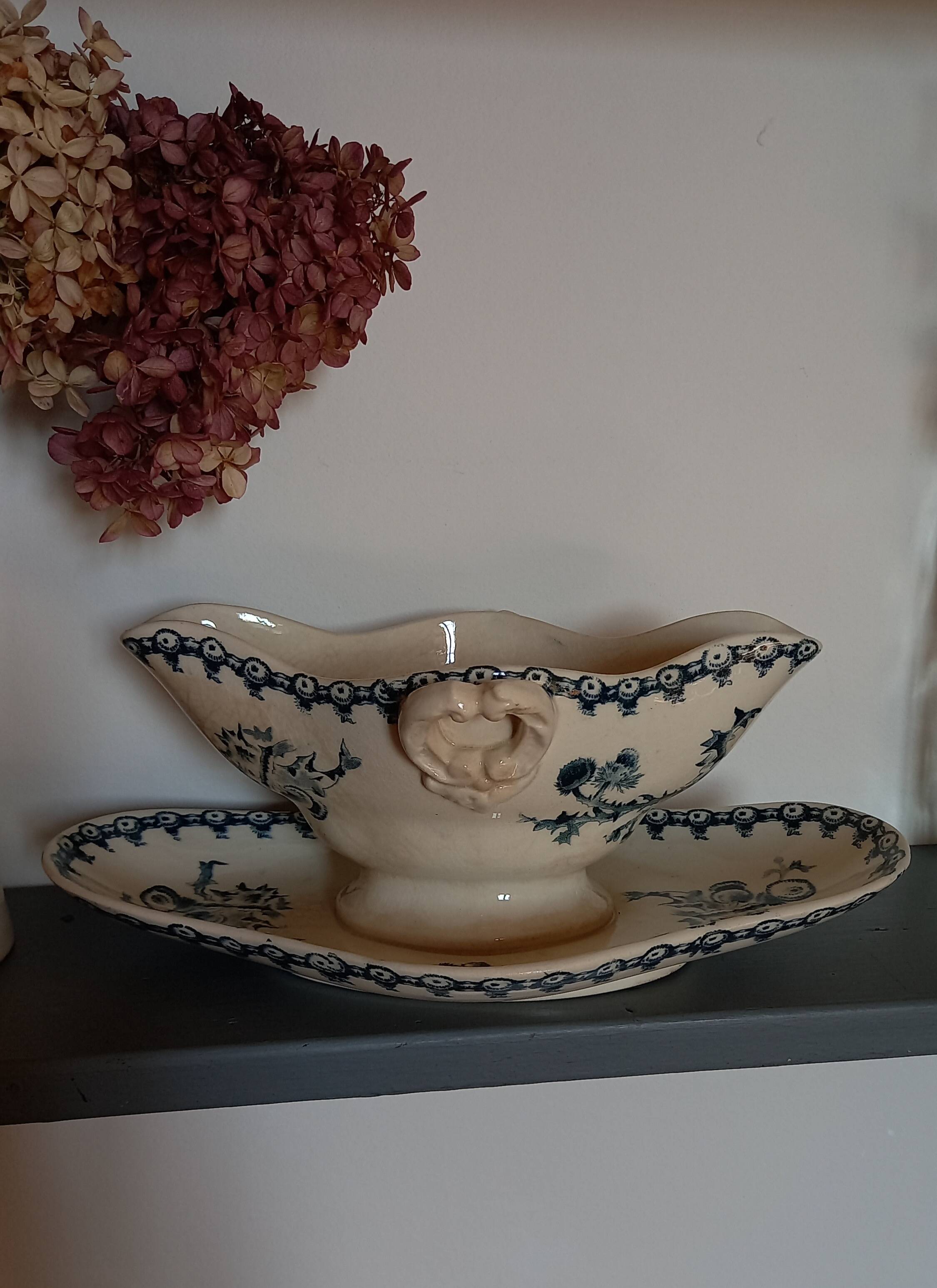 Old gravy boat on frame in terre de fer earthenware by gien, “chardons” model in blue-green