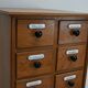 German Oak Apothecary Cabinet with Enamel Shields, 1940s