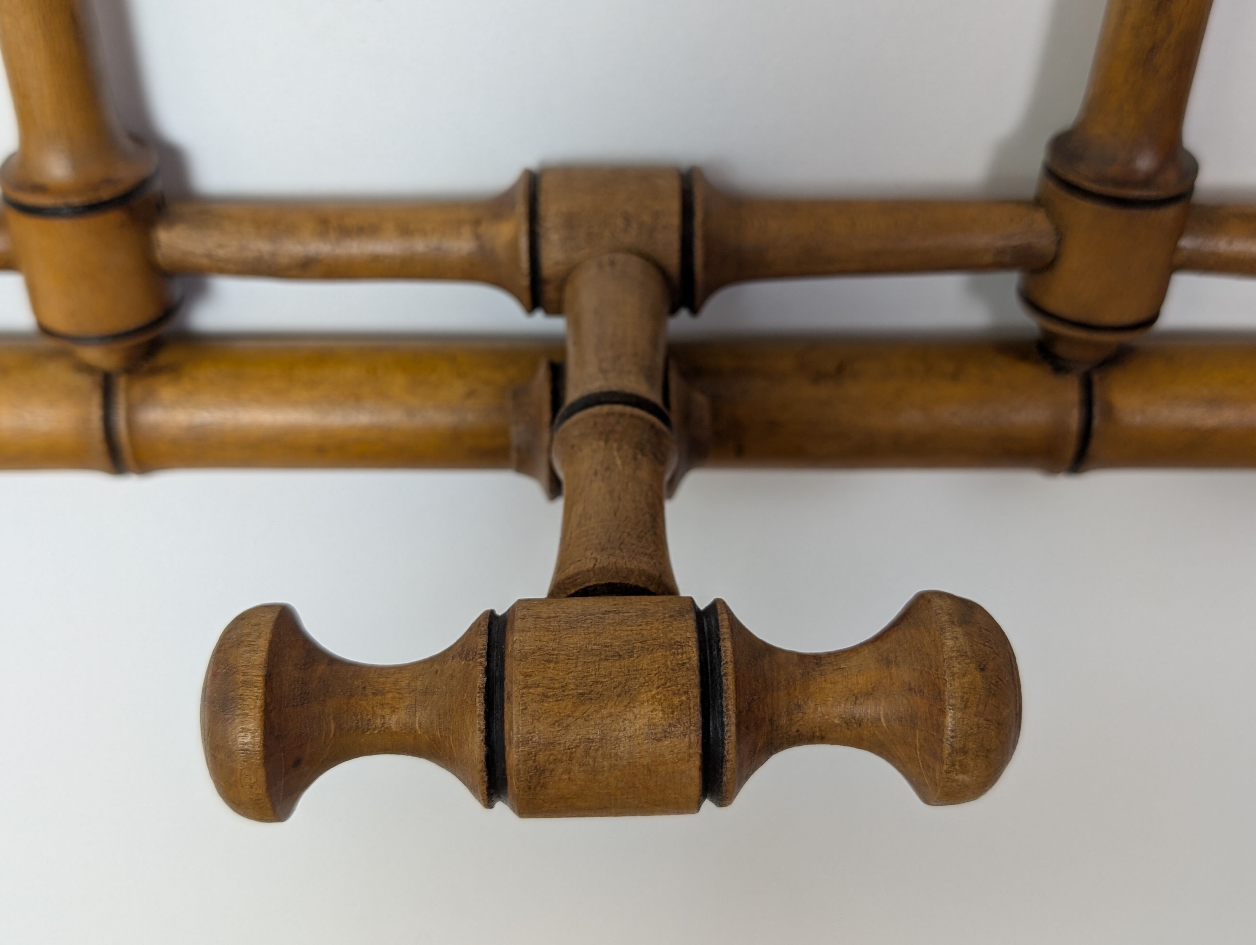 Wall-mounted coat rack made of turned wood
