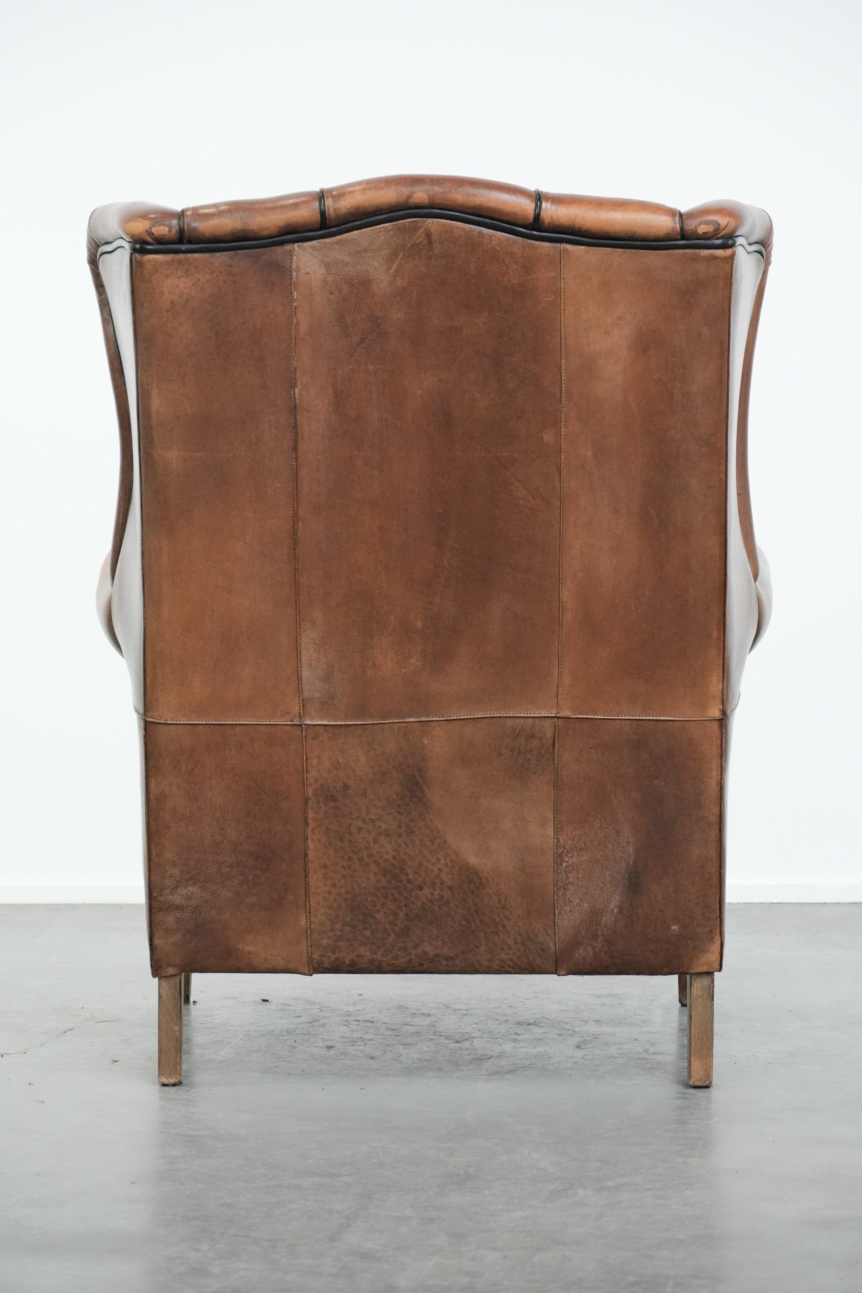 Sheepskin wingback armchair with beautiful colours in good condition