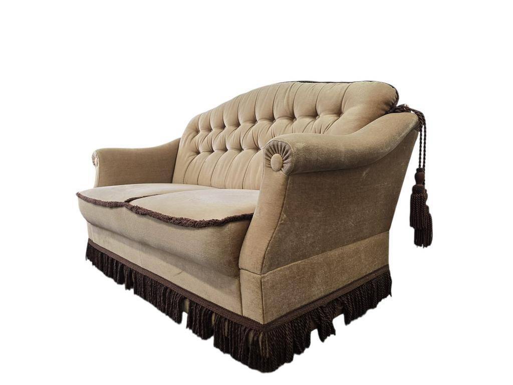 Vintage beige two-seater canapé with fringes.