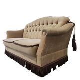 Vintage beige two-seater canapé with fringes.