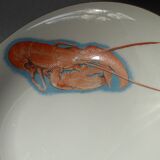Eight hollow plates decorated with lobsters