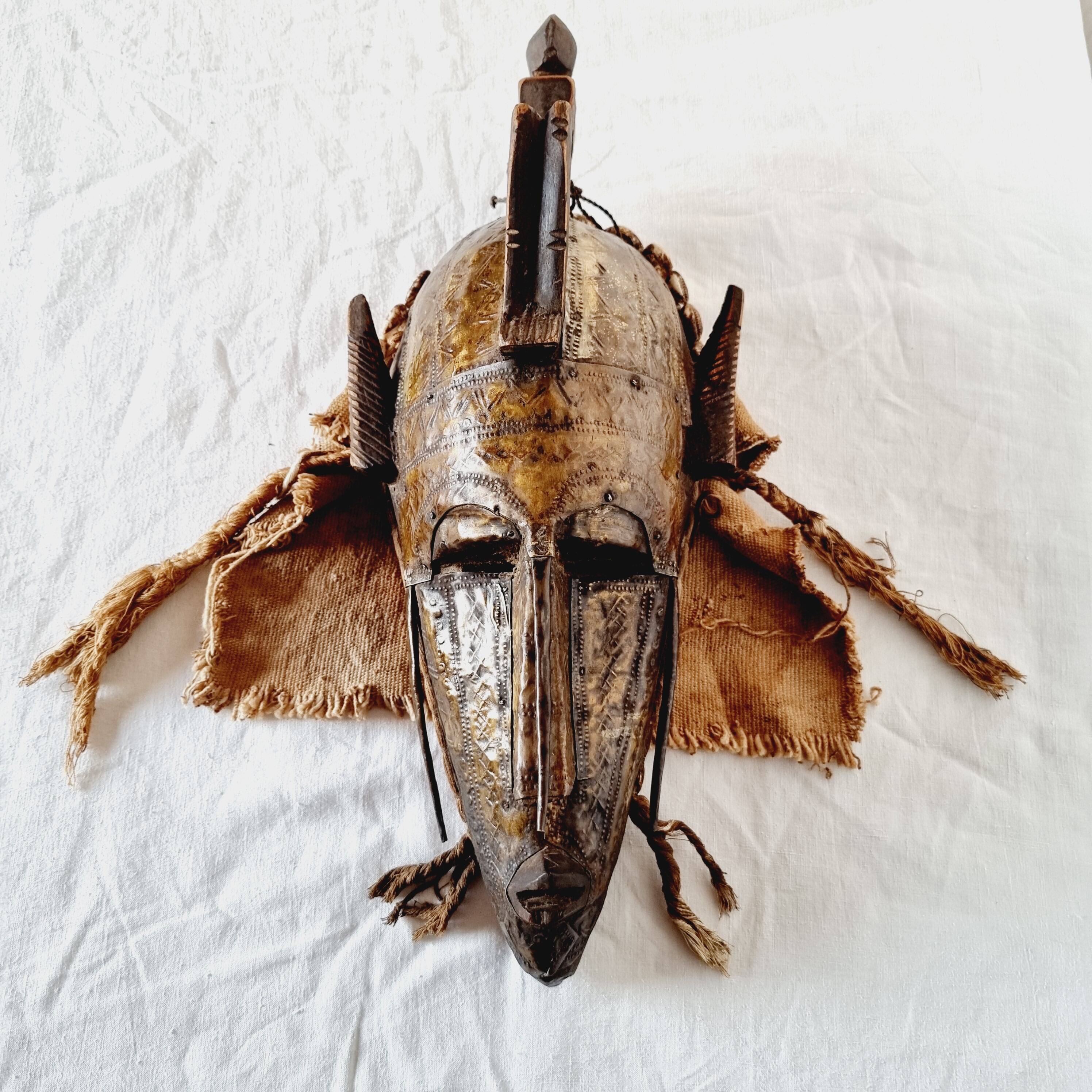 African mask from Mali from the N'Tomo tribe of Marka covered in chiseled brass