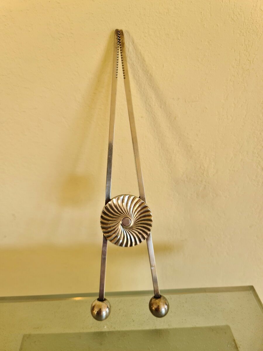 Ice cube or sugar tongs in silver metal