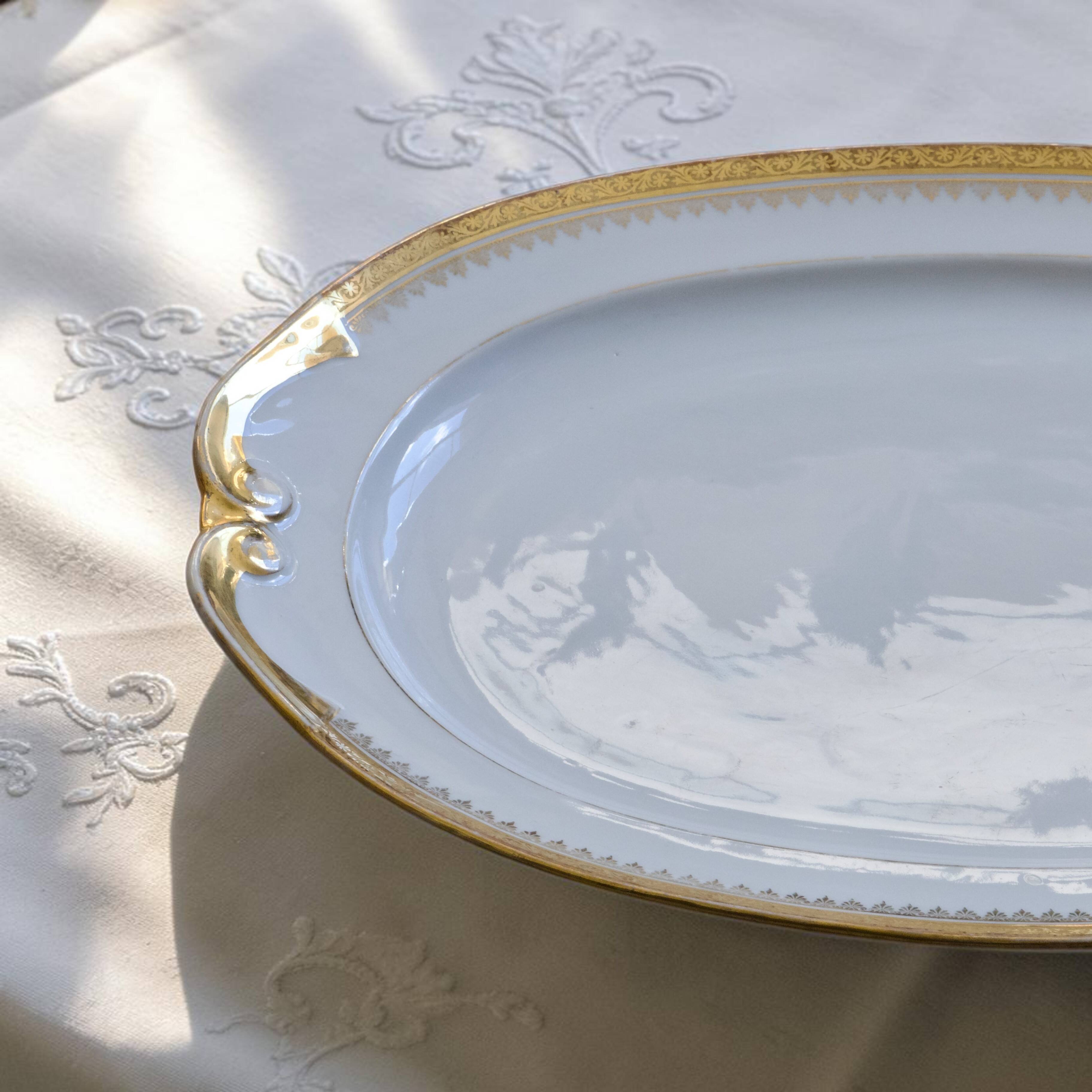 Very large oval dish with gold trim in Limoges porcelain by Peconnet.