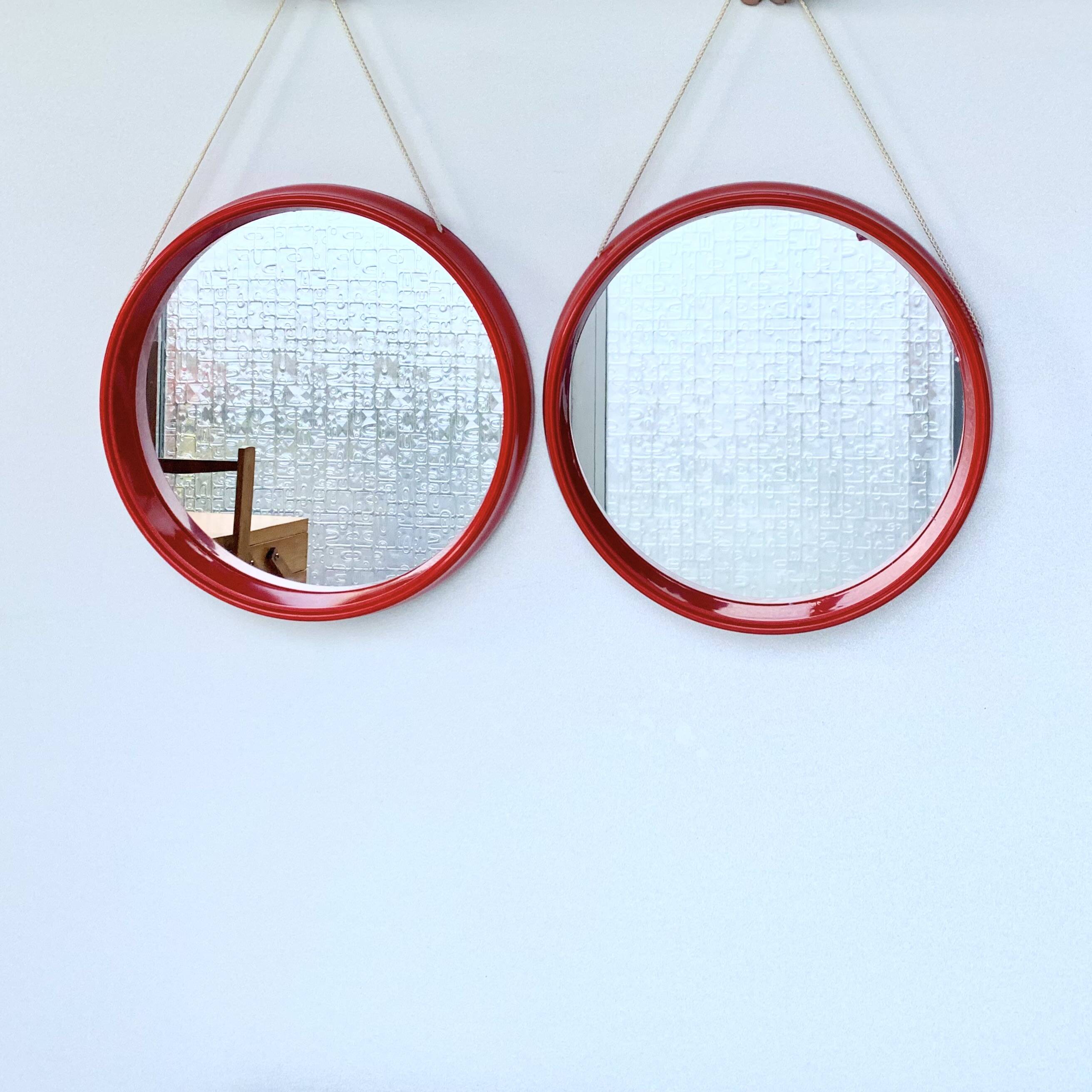 Pair of vintage round red plastic mirrors