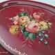 Russian plate in painted sheet metal burgundy old pink decoration and golden frieze