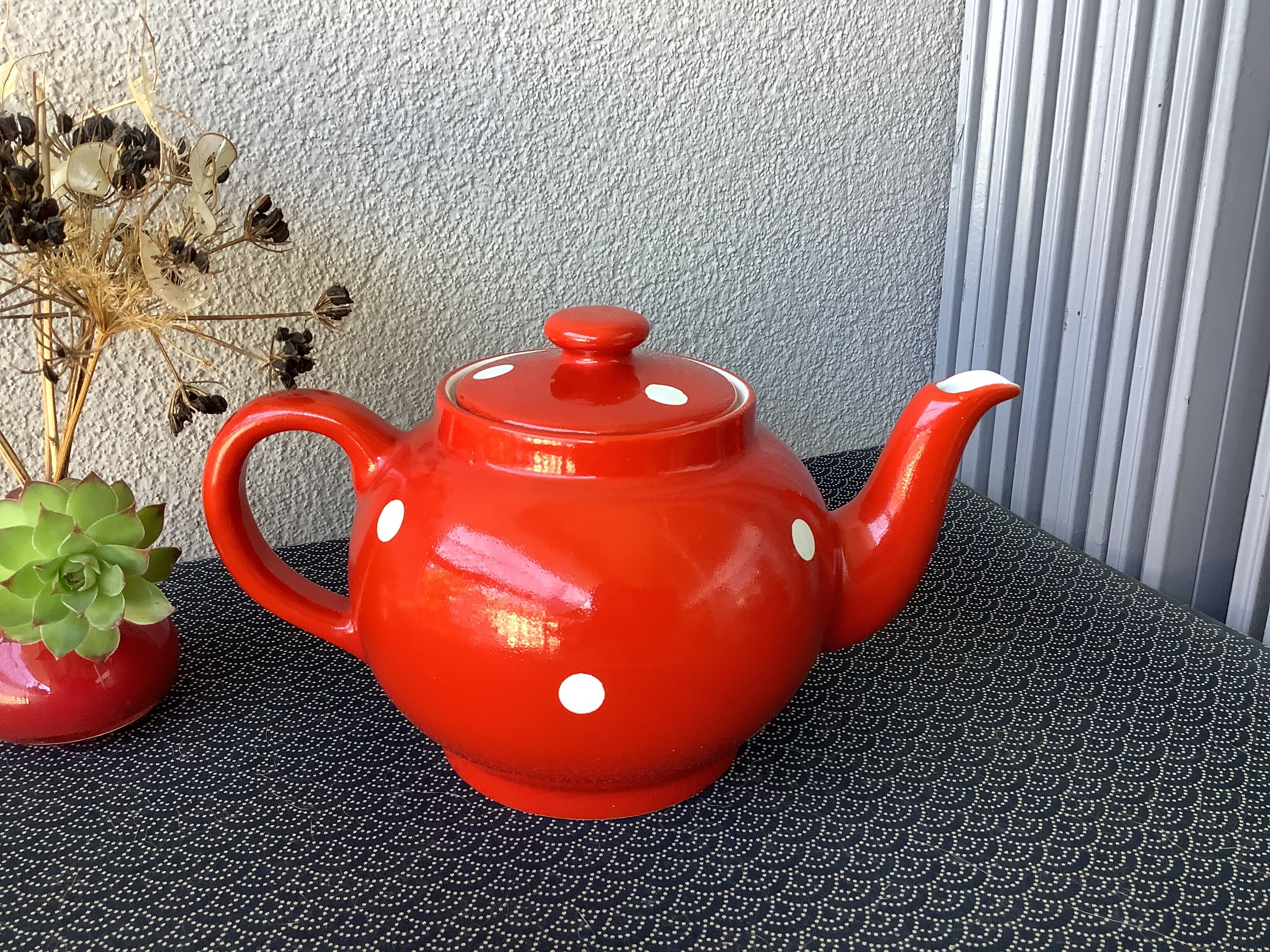 Vintage red teapot with white polka dots