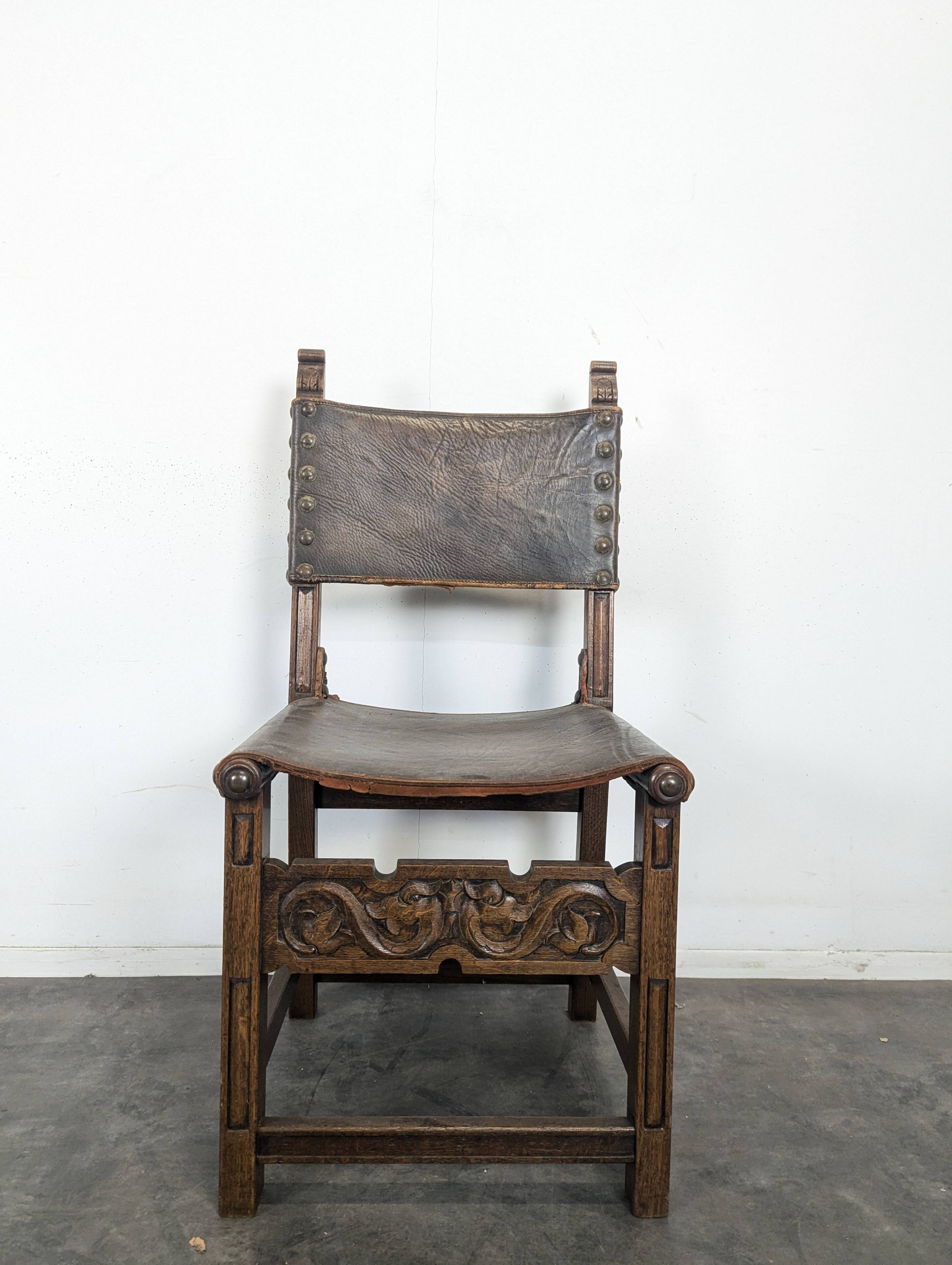 Set of 8 Gothic-style chairs in oak and studded leather.